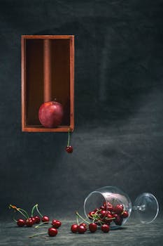 A group of llamas in a mountainous winter setting, featuring snow-capped peaks and fog.