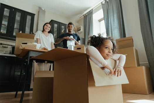 Child playing in cardboard box in a cozy setting