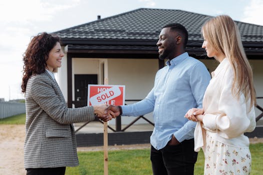 Confident female real estate agent in a hard hat holding a house key symbolizing property acquisition