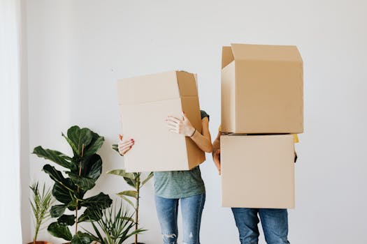 A family unpacks moving boxes in their new home kitchen, creating a cozy atmosphere, exemplifying Rent to Own Residences for Canadians Nationwide.