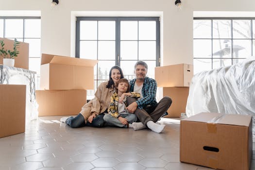 Family enjoying selfie time while surrounded by moving boxes in new apartment.