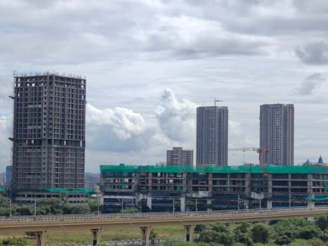 Architectural floor plans with helmet and keys on sunlit floor, perfect for real estate or construction themes.