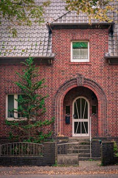 Elegant two-storey house with garage, showcasing modern architecture and residential charm. Rent to Own Housing Pathways for Canadians This Month