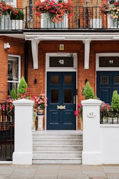 Rent Own Homes Canada 2024 A picturesque townhouse in London framed by lush green trees, highlighting architectural charm.